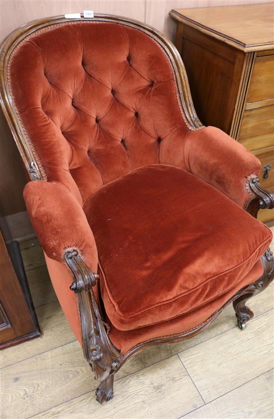 A late Victorian buttoned back tub chair
